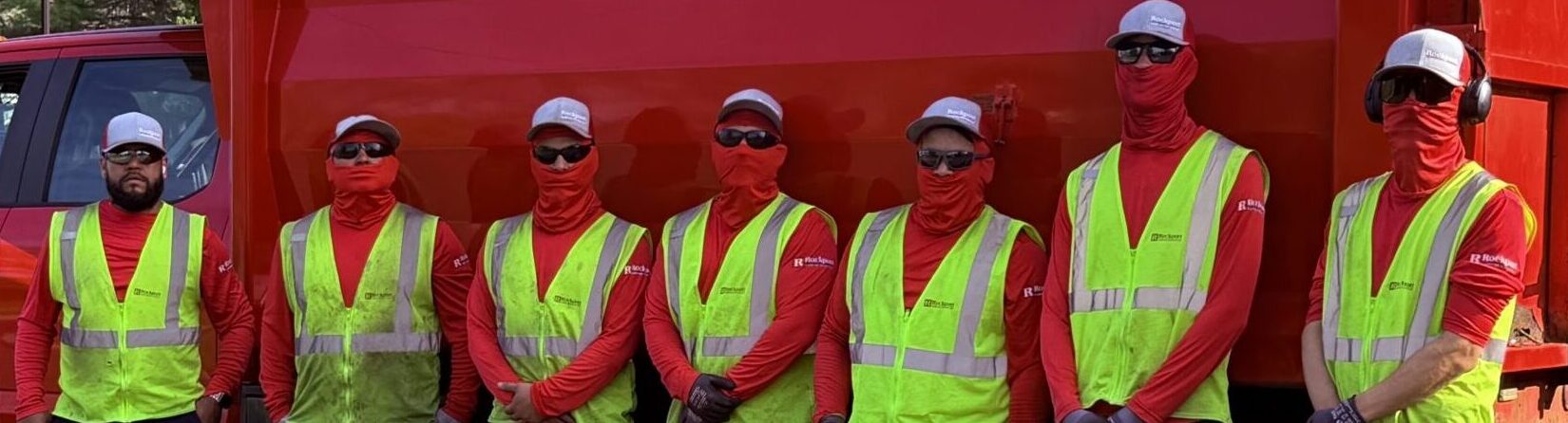 The Rockport Landscape Services crew in hi-vis safety vests in front of a Rockport truck
